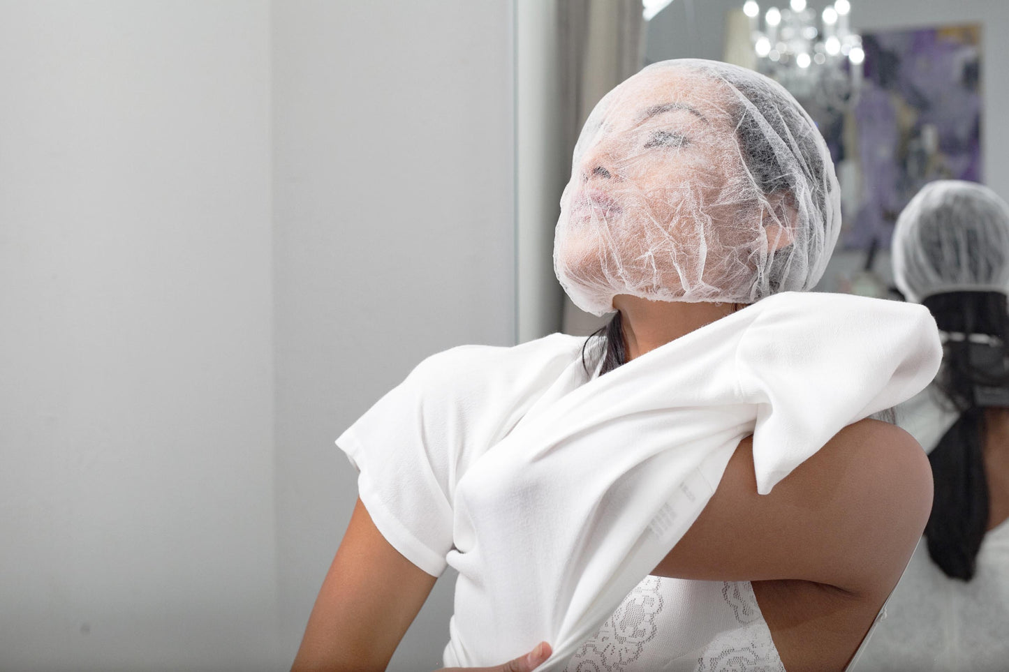 Woman wearing white Glam Face Saver